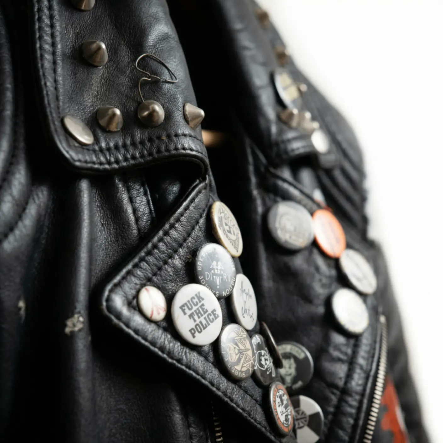 Studded leather jacket with pins